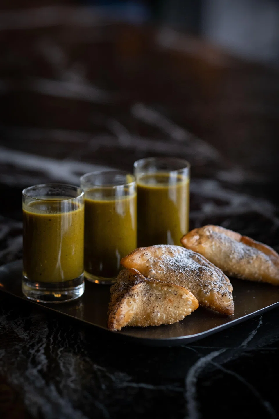 Crispy fatayer are triangular pastries stuffed with cheese and spinach.