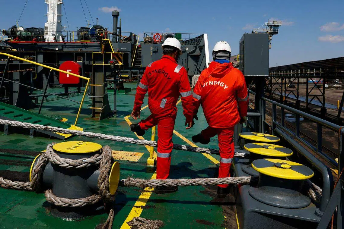 Crew members walk on the deck of the bulk carrier Klara Oldendorff, one of the ships stuck in the Port of Baltimore following the collapse of the Francis Scott Key Bridge, in Baltimore, Maryland, U.S., March 29, 2024. REUTERS/Julia Nikhinson