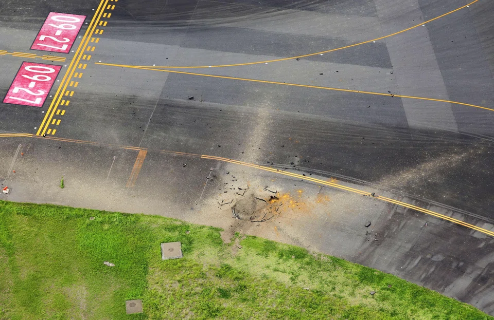 An aerial view taken from a helicopter shows a crater from an explosion after a WW2-era bomb exploded on a taxiway at Miyazaki Airport.