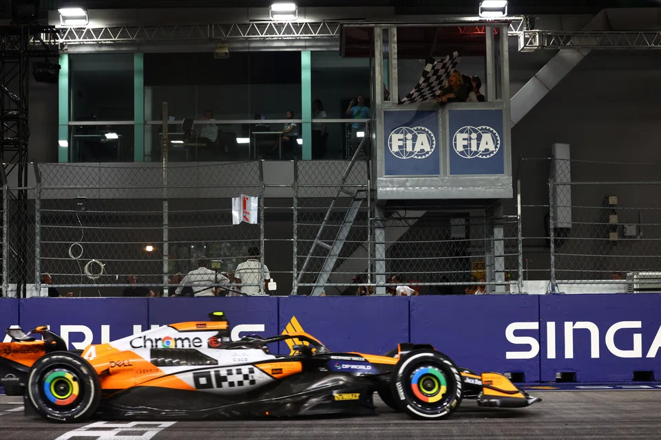 McLaren's Lando Norris passing the chequered flag to win the Singapore Grand Prix.