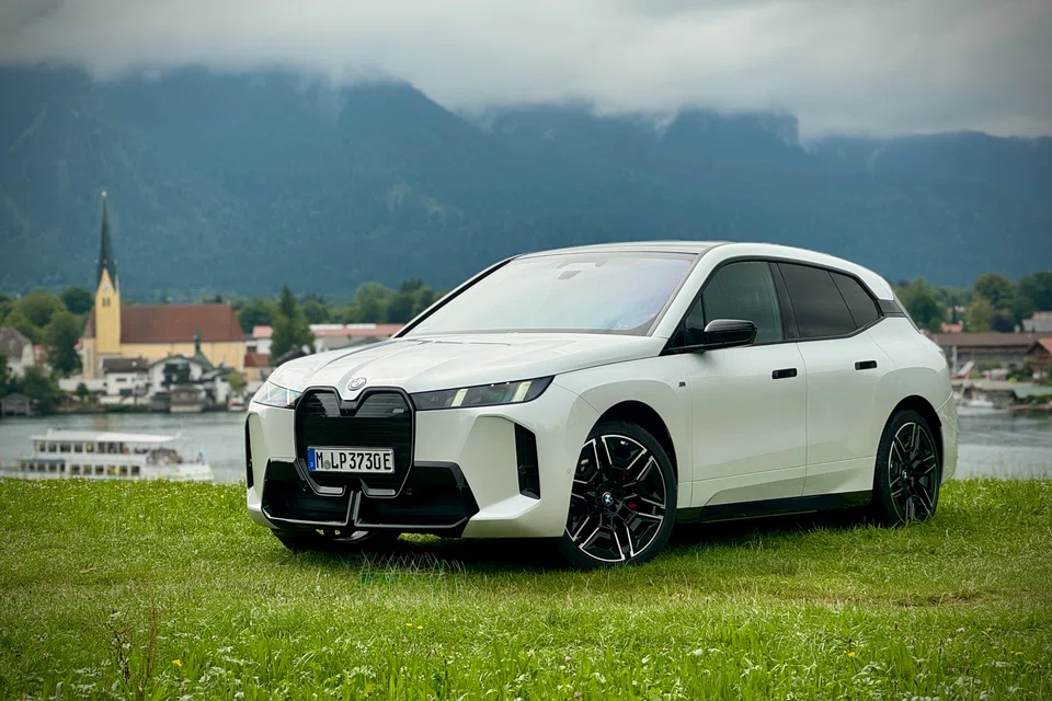 After a facelift, the BMW iX still looks mostly the same, with its slab-sided body and carbon shell, but the grille now lights up and the headlights look a bit sharper.
