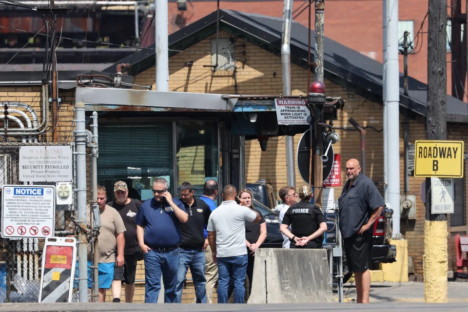 US Senator John Fetterman (right) speaks with a police officer outside of US Steel's Clairton Coke Works following an explosion at the plant in Clairton, Pennsylvania, Aug 11, 2025. 