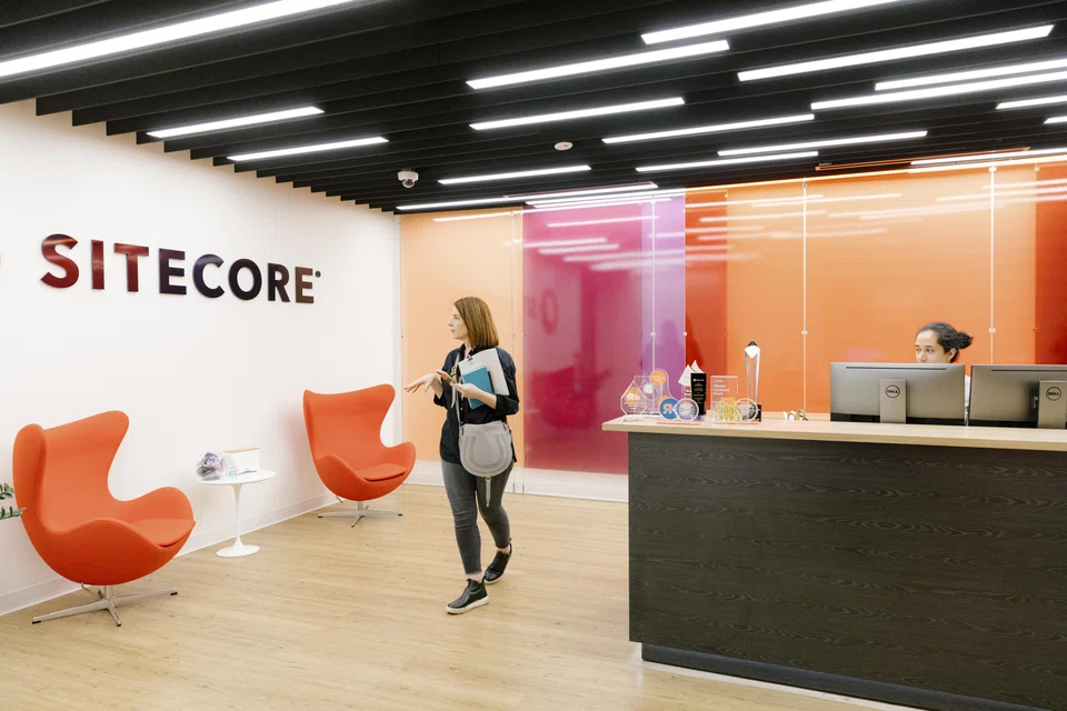 Brandi Susewitz, who runs an office furniture resale business called Reseat, looks at two red Arne Jacobsen Egg Chairs during a visit to Sitecore in downtown San Francisco. As tech companies cut costs and move to remote work, their left behind office furniture has become part of a booming trade. 