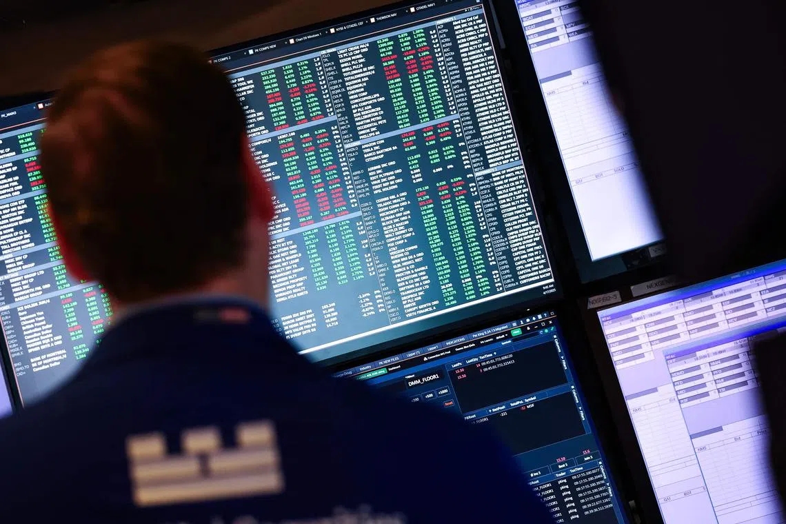 A trader works on the floor of the New York Stock Exchange (NYSE) at the opening bell in New York City, on April 17, 2025. Wall Street stocks were mixed early Thursday as tech shares attempted to rebound from the prior session's rout while the Dow was pressured by UnitedHealth Group's disappointing profit outlook. (Photo by TIMOTHY A. CLARY / AFP)