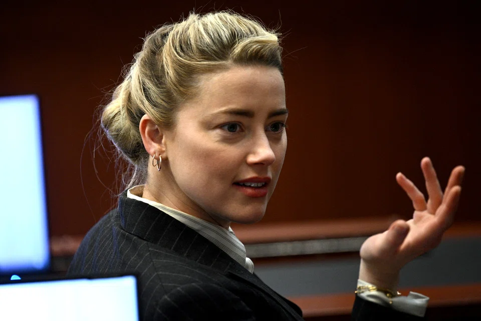 Amber Heard gestures during a defamation case against her by ex-husband, actor Johnny Depp, at Fairfax County Circuit Courthouse in Fairfax, Virginia on May 17, 2022. 