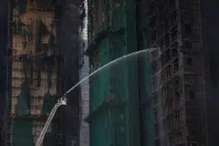 A fire in late November that ripped through seven high-rise towers and killed more than 160 people. 