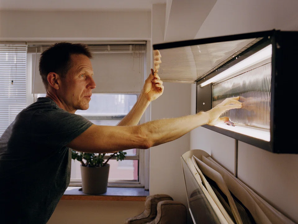 Joshua Spodek adjusting his linear zoetrope at his apartment in the West Village of New York, Oct 22, 2024. 