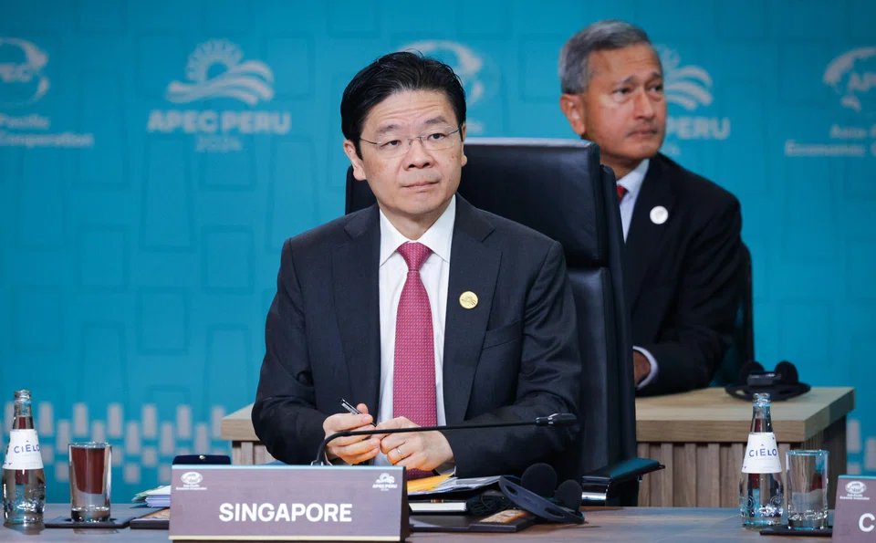 Prime Minister Lawrence Wong with Foreign Minister Vivian Balakrishnan at the Apec Economic Leaders’ Meeting Retreat in Lima, Peru, earlier in November. Balakrishnan is also with him on the current trip to Bangkok. 