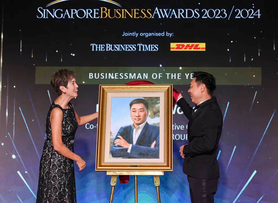Josephine Teo, Minister for  Communications and Information and Charles Wong, co-founder & CEO, Charles & Keith Group, unveiling the Businessman of the Year portrait.