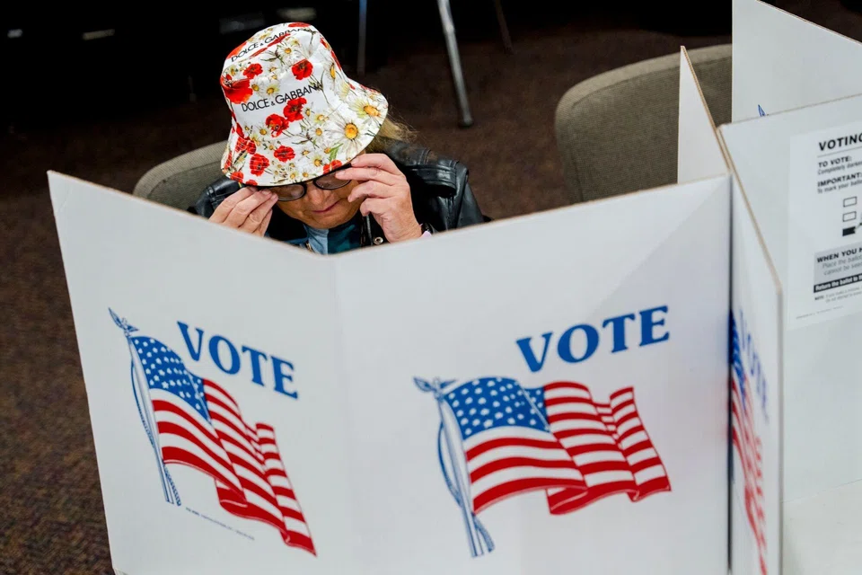 A voter at the Michigan primary election on Aug 6. The competition between the Republican and Democratic parties has been transformed into a zero-sum game between two ideological entities, which leaves little room for centrists.