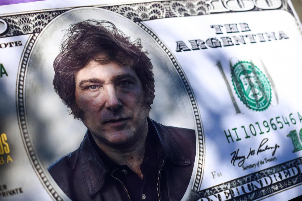 A US$100 bill cut-out with Argentina president-elect Javier Milei's face printed on it. The question is whether his radical free market moves can revive Argentina's economy.