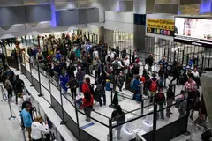 Travelers wait in line at a Transportation Security Administration checkpoint at George Bush Intercontinental Airport (IAH) in Houston, Texas, Nov 9, 2025. 