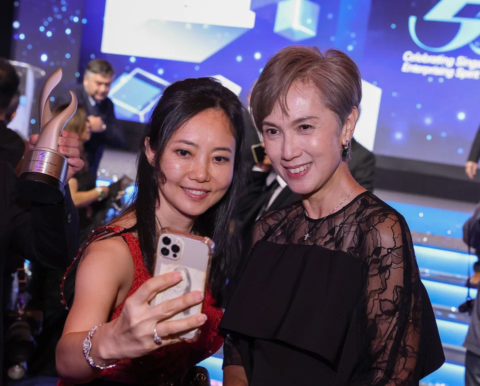 Yeah Li Ching (left), president of the E50 association, taking a selfie with guest of honour Josephine Teo.