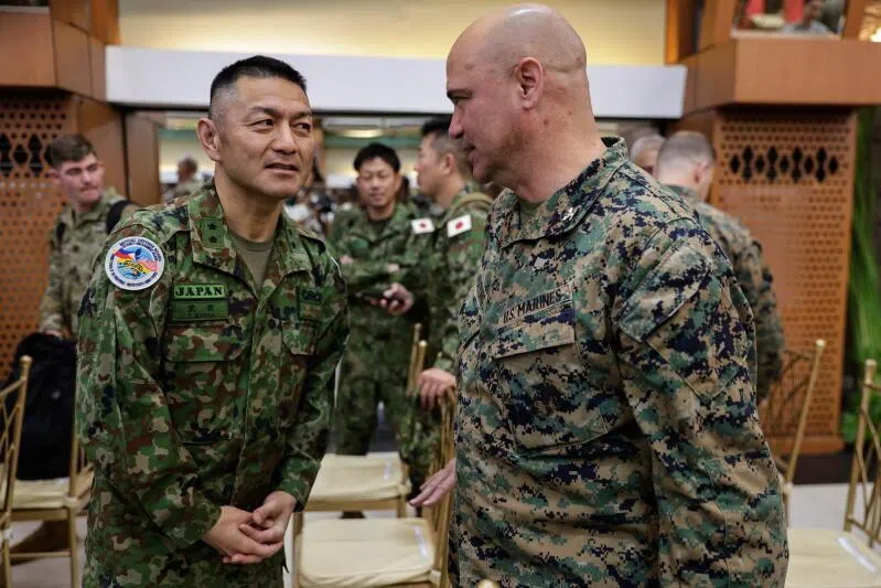 Military officers from Japan (L) and the United States (R) talk to each other during opening ceremonies of the Philippines-US Exercise Balikatan.