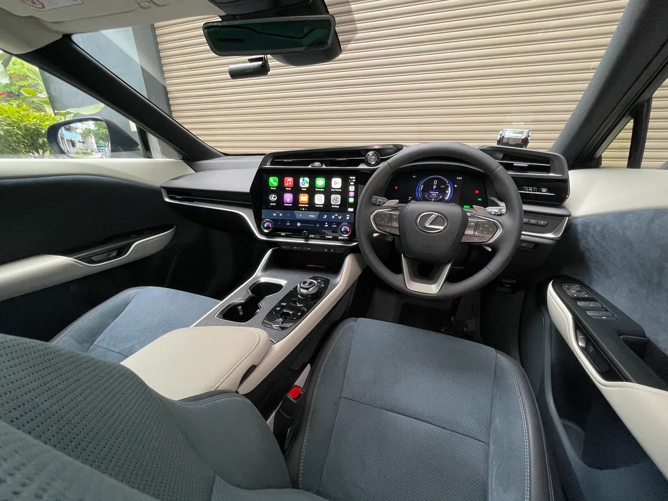 In an obvious break from the polished wood and opulent leather of Lexuses past, the RZ has a pared-down interior, with a huge, 14-inch touchscreen as its centrepiece. 