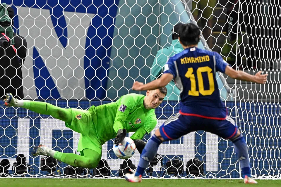 Croatia's Dominik Livakovic saves a penalty from Japan's Takumi Minamino at the Al-Janoub Stadium in Al-Wakrah, Doha on Dec 5, 2022. 