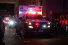 NYPD officers and other police officers wait for the ambulance to transfer slain NYPD officer Didarul Islam, who was killed during a mass shooting in Midtown Manhattan, New York City, July 29, 2025.