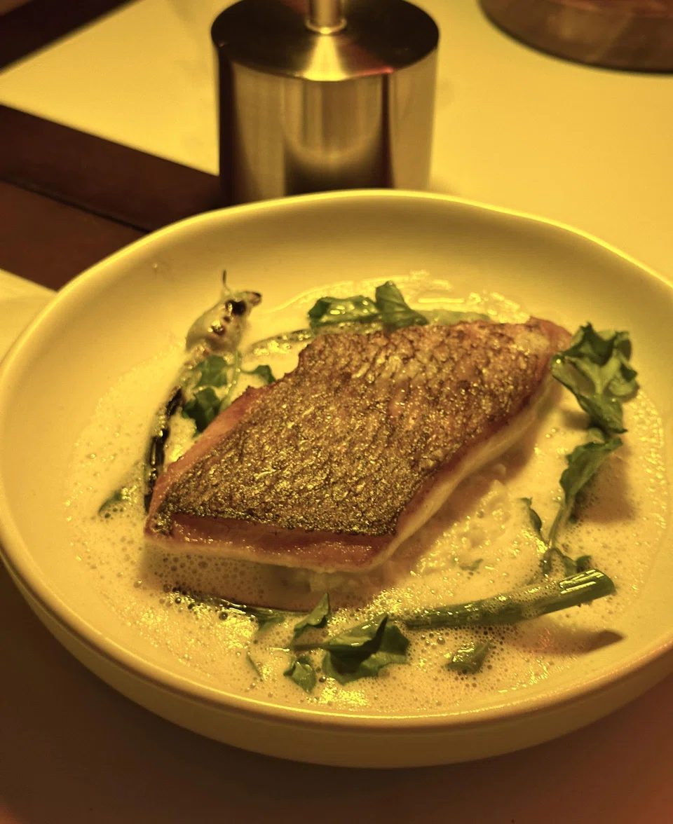 Pan-fried sea bream in a thick beurre blanc sauce.
