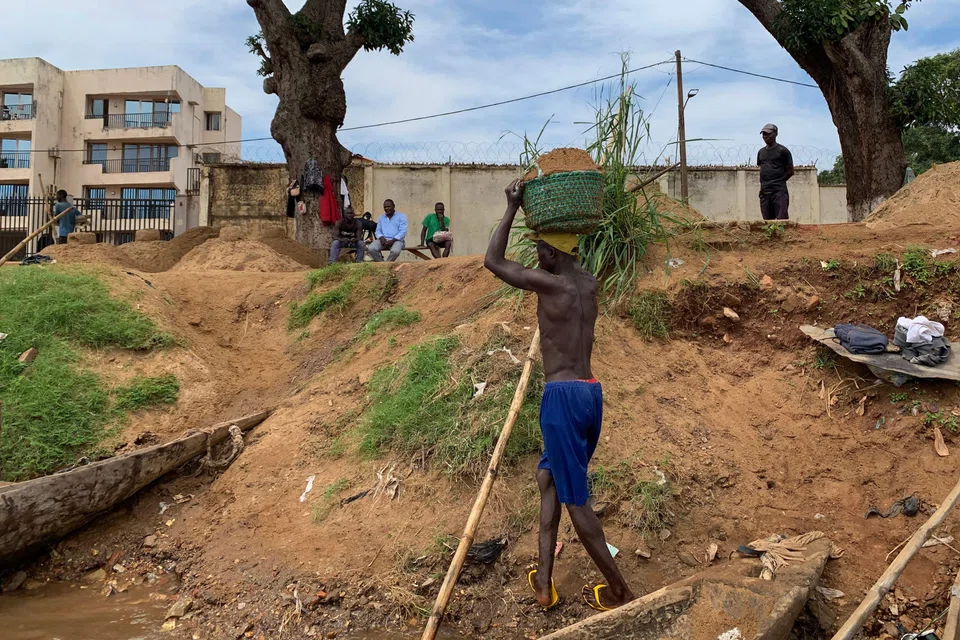 A worker collecting sand for construction from the Ubangi River in the Central African Republic. It is a risky job that involves diving deep into the river, without an oxygen tank. The poorer half of the world deserves opportunities to better their lives, says the writer.