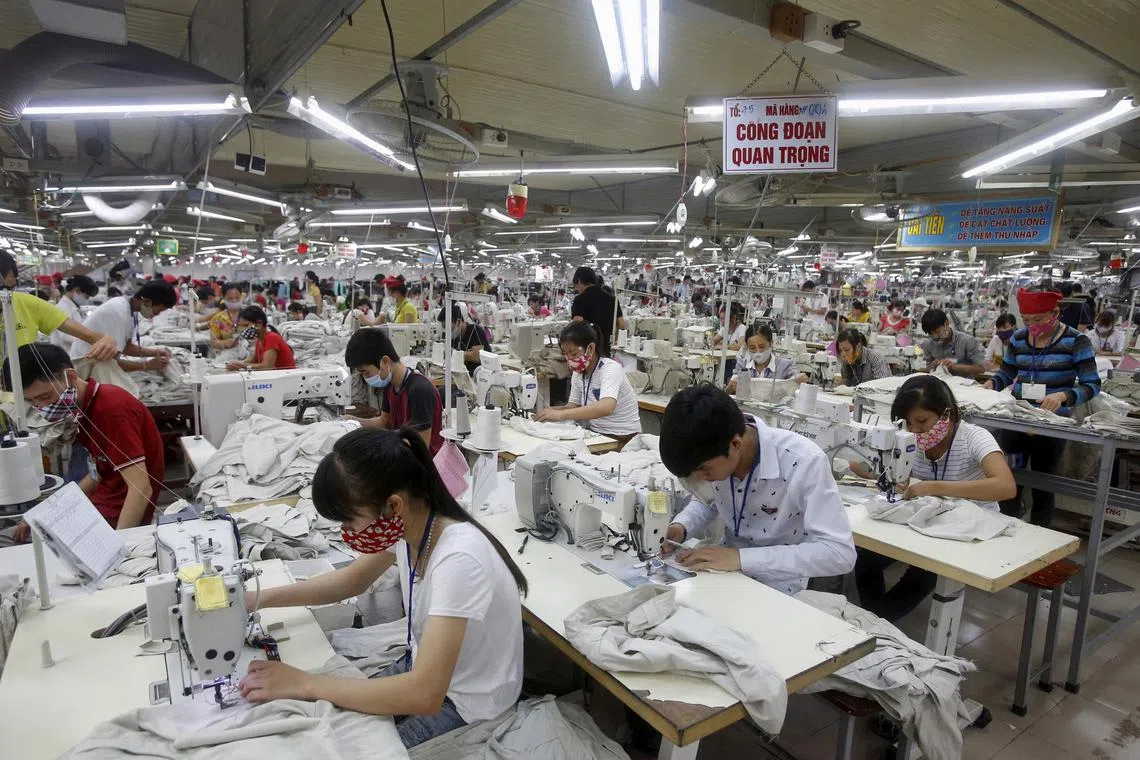 Garment workers work at a factory in Bac Giang province, near Hanoi in Vietnam, Oct 21, 2015. Extreme heat and flooding could erase US$65 billion in apparel export earnings from Bangladesh, Cambodia, Pakistan and Vietnam by 2030, research from asset manager Schroders and the Global Labor Institute found last year.