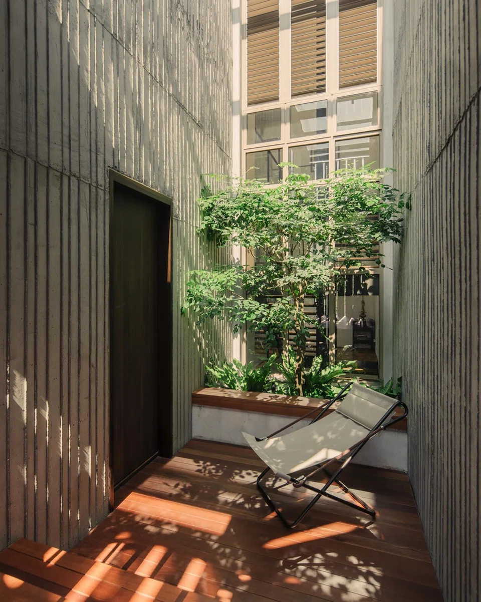 Raw concrete juxtaposes with warm timber in the second-storey courtyard. 