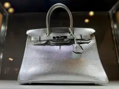 File photo of a Hermes Silver Metallic Chevre Birkin 30 handbag up for auction at Sotheby's in New York City, June 1, 2023. The class-action lawsuit argues that would-be customers have to spend tens of thousands of dollars on scarves, shoes and belts just to be given the opportunity to get their hands on one of the world’s most sought-after purses.