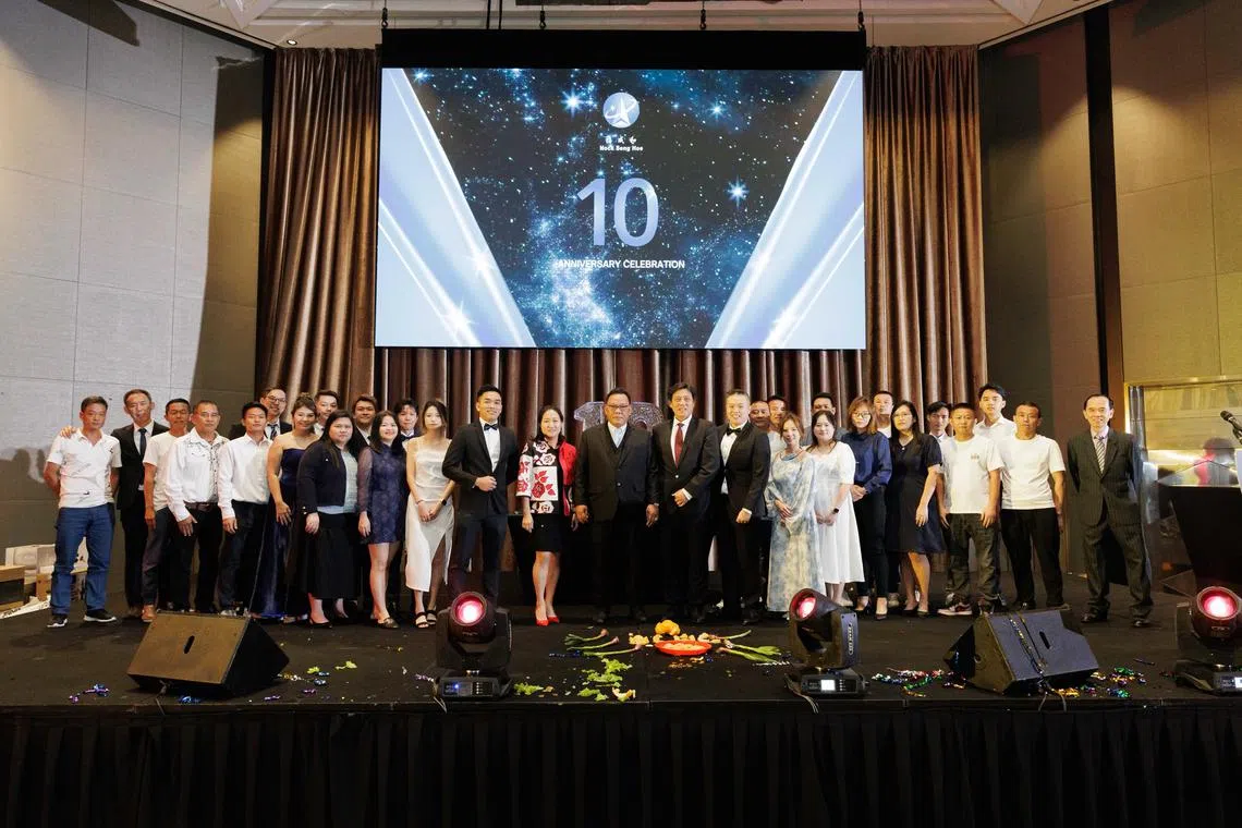 Hock Seng Hoe Metal managing director Sam Chee Keong (centre) and executive director Chan Lee Ying (left of centre) at the company's celebration of its 10th anniversary.