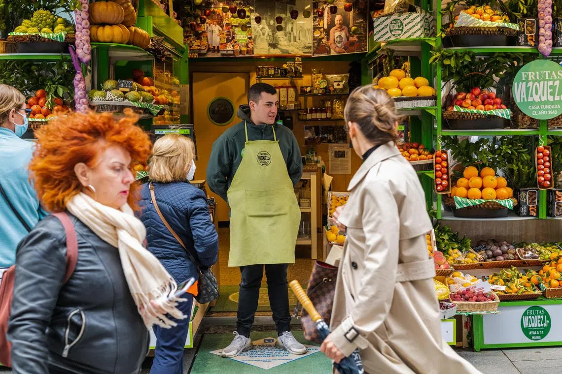 A vendor waits for customers at a fresh produce store in Madrid, Spain; April 20, 2022. The hit to household real incomes in Europe from the energy crunch is greater than in any other region of the world. 