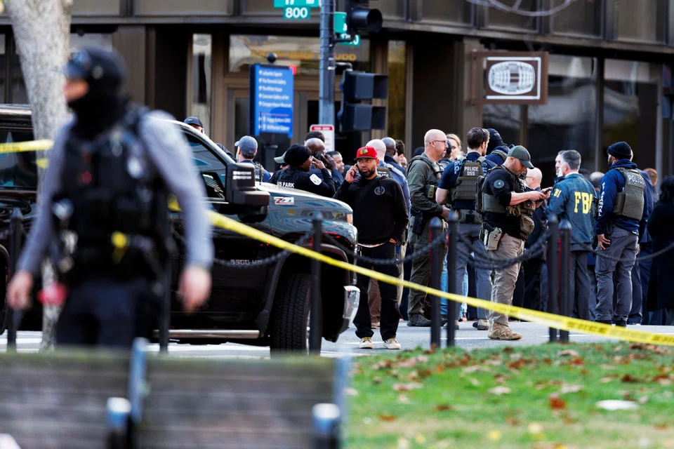 Law enforcement officers stand close to the scene where two West Virginia National Guard members were shot in Washington, D.C., Nov 26, 2025.