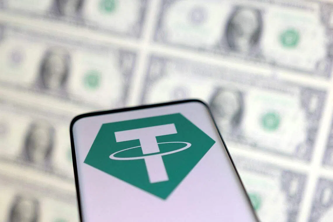 FILE PHOTO: Smartphone with Tether logo is placed on displayed U.S. dollars in this illustration taken, May 12, 2022. REUTERS/Dado Ruvic/Illustration/File Photo