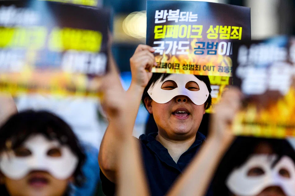 Activists wearing eye masks, hold posters reading ‘Repeated deepfake sex crimes, the state is an accomplice too’ during a protest against deepfake porn in Seoul on August 30, 2024. 
