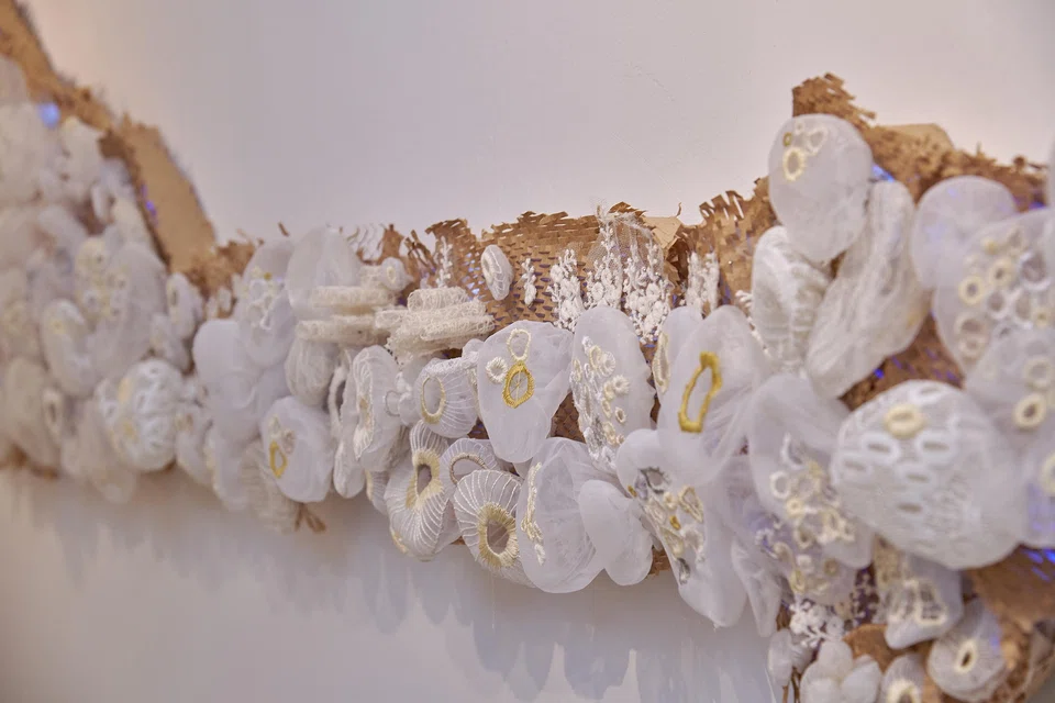 Artist Agatha Lee uses organza from discarded wedding dresses to craft a fragile coral reef-like art installation.