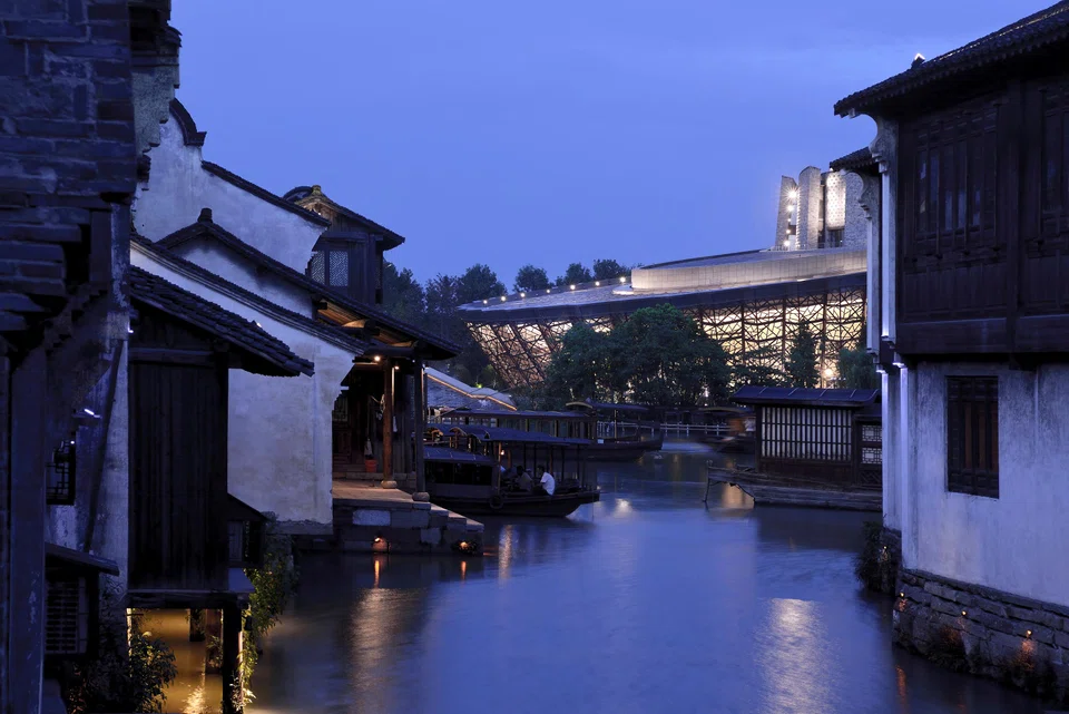 The Wuzhen Theater embodies the narrative of two lotus flowers with an interlocking brick and timber lattice shell.
