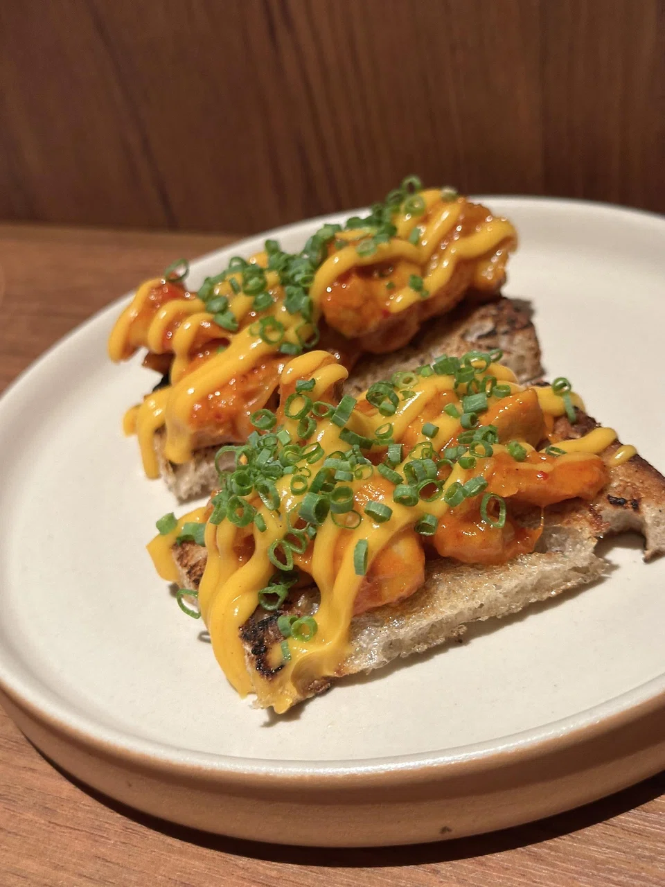 Sourdough toast topped with spicy fried chicken and cheese.