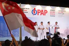 Prime Minister Lawrence Wong addressing supporters together with his Marsiling-Yew Tee GRC teammates –  Hany Soh, Senior Minister of State for Defence and Manpower Zaqy Mohamad and Alex Yam – at Yio Chu Kang Stadium on May 4. Singapore’s fundamentals are what keep it attractive to investors, say economists and trade chambers.