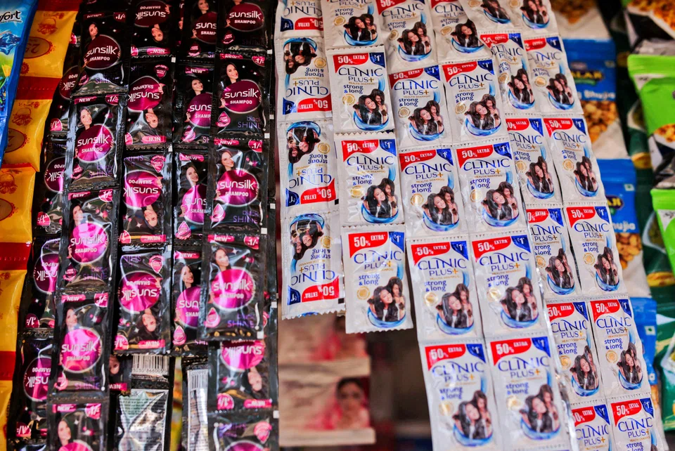 Plastic sachets of Unilever's Sunsilk and Clinic Plus shampoo hang outside a shop in Mumbai, India, May 7, 2022. India’s elite classes are becoming pickier consumers, fueling the success of organic personal-care brands backed by slick social media marketing campaigns. 