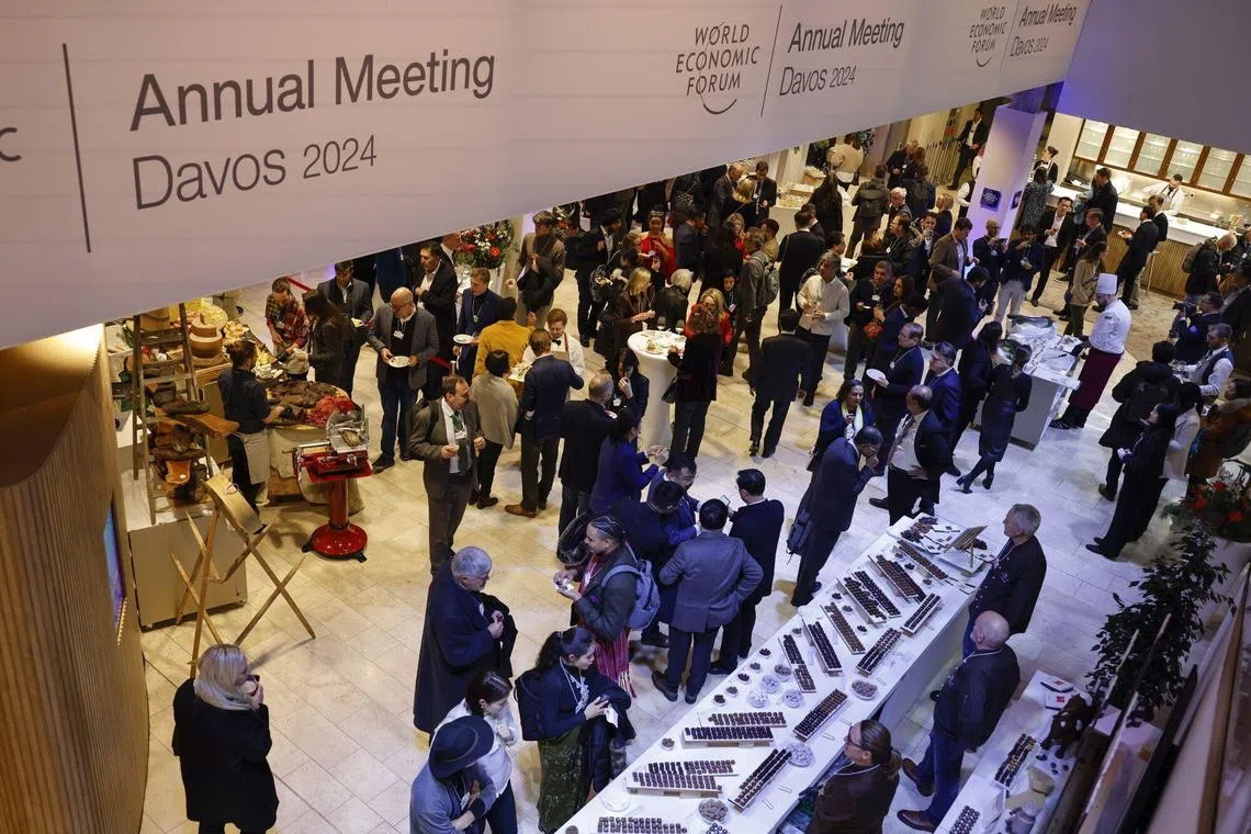 Attendees attend the welcome reception event ahead of the World Economic Forum (WEF) in Davos, Switzerland, on January 15, 2024. The annual gathering of political leaders, top executives and celebrities runs from Jan 15 to 19.