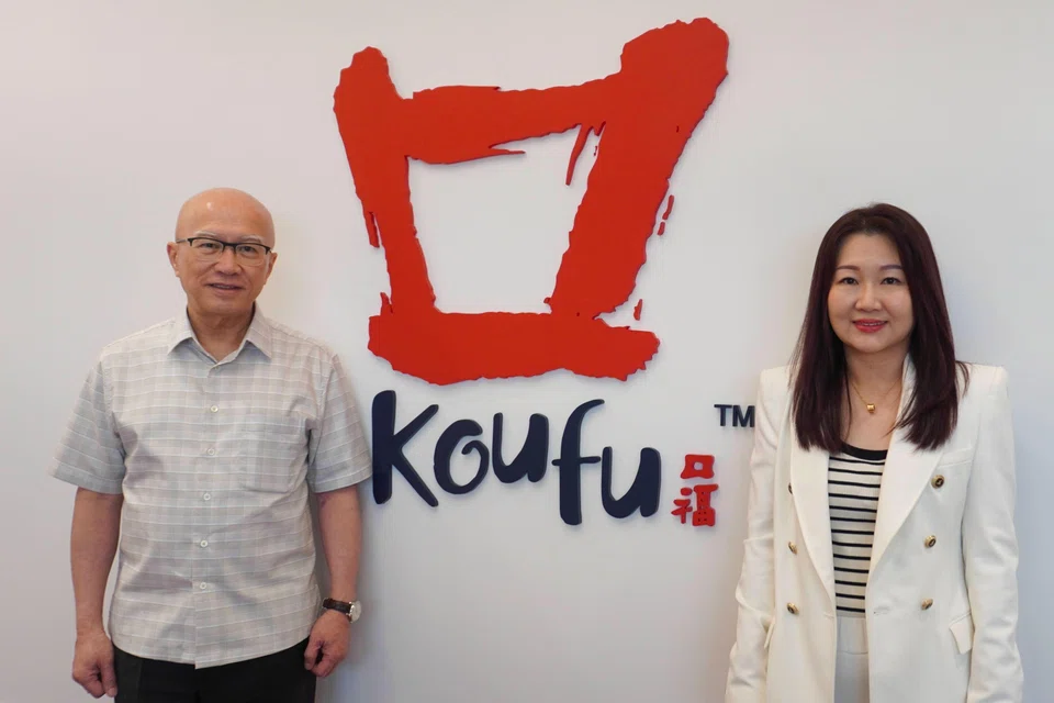 Koufu Group chairman Pang Lim (left) says handing over the reins to Chua Sher Lin is part of a "long-term plan established years ago". 