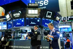 The S&P 500 and the Nasdaq hovered near their three-week lows as persistent uncertainty over rate cuts and concerns about lofty tech valuations continued to weigh on market sentiment.