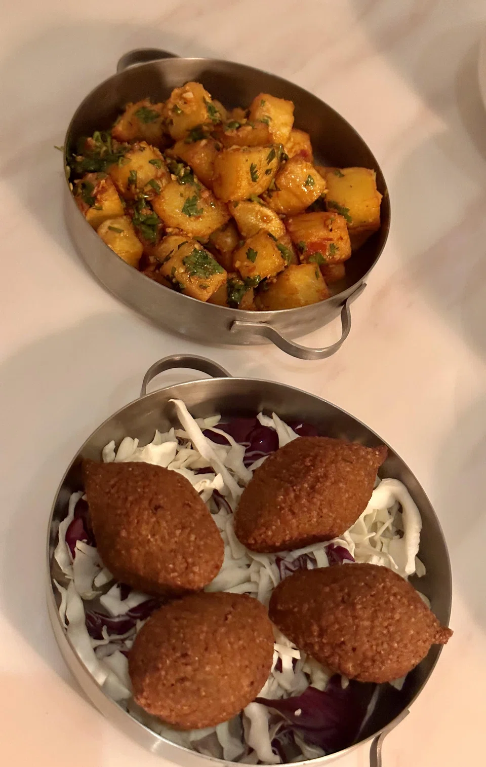 Batata Harra are cheerful fried potatoes in harissa sauce while kibbeh balls are gamey nuggets of minced lamb.