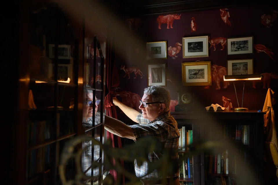Mark Dion's Extinction Club room features wallpaper peppered with an array of animals; worn leather chairs; and curiosity cabinets filled with fossils, keys and mini liquor bottles. 