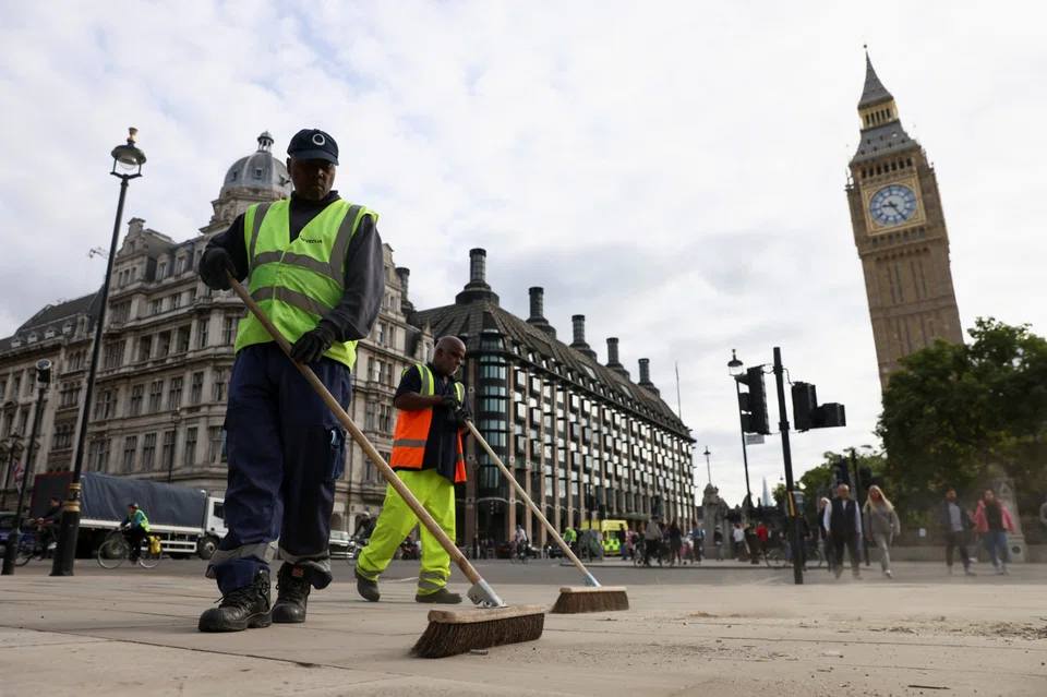 Cleaners sweep the streets in Parliament Square, following the funeral of Britain's Queen Elizabeth, in London, Britain Sep 20, 2022. 