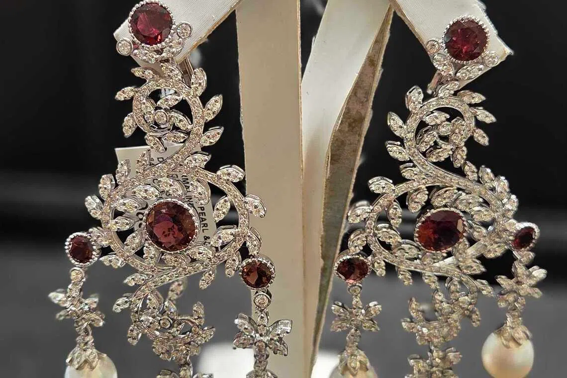 Savvy consumers are turning to pre-loved jewellery for both adornment and investment. Above: A pair of chandelier earrings in white gold with diamonds, pearls and tourmalines from D'Lux Jewel, S$19,839. 