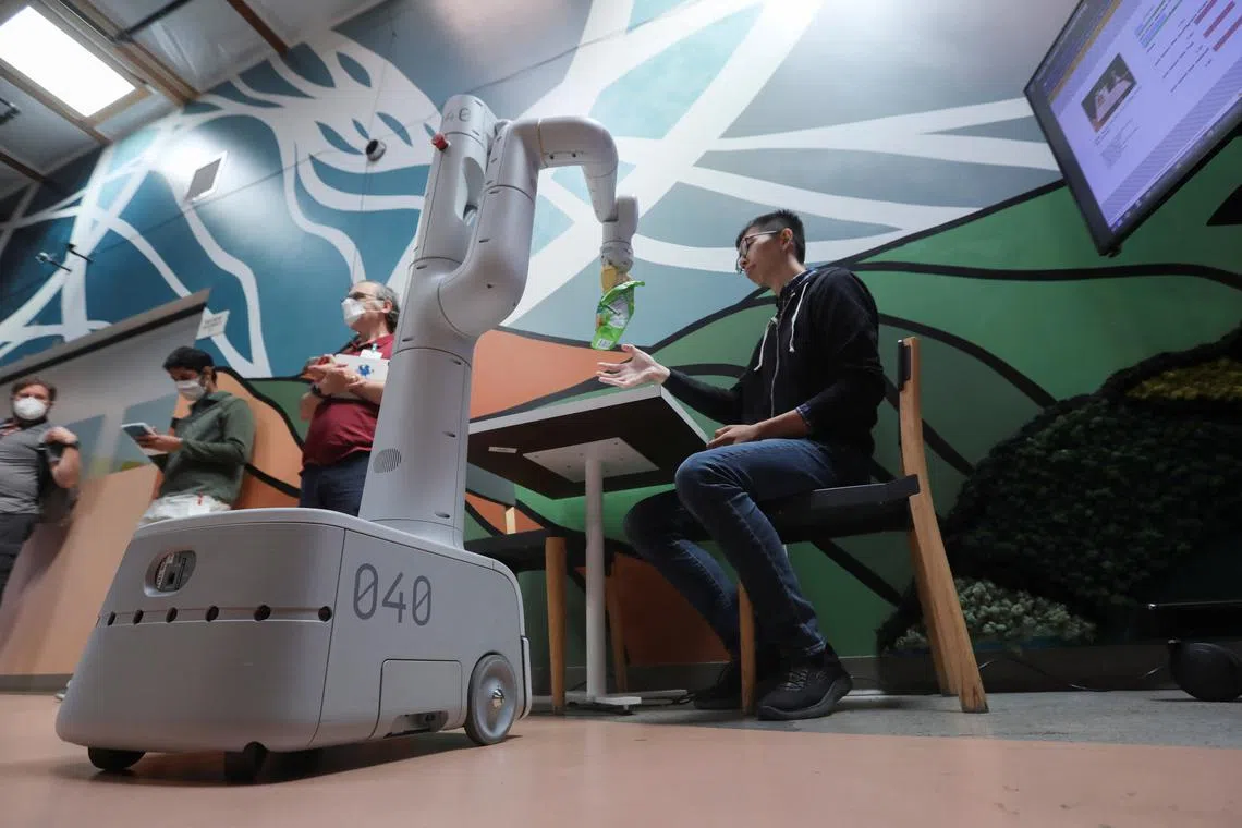A Google robot carrying a bag of chips during a media demo at a micro-kitchen in Google’s robotics research space in Mountain View, California, US; August 2022.  Particularly in the hospitality and healthcare sectors in Singapore, critical business needs will demand an acceleration of robotics adoption.