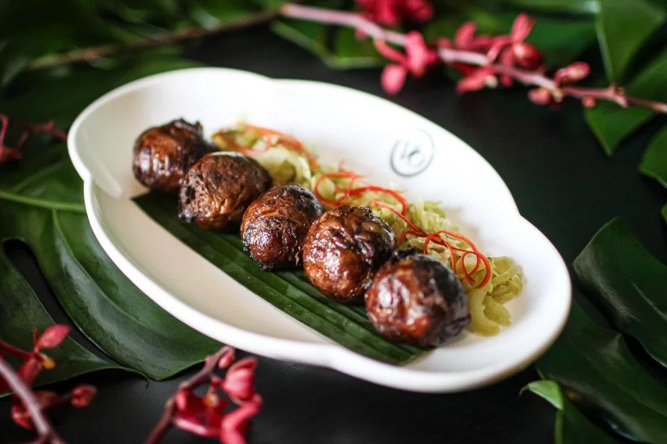 Hati babi bungkus are pork liver balls served with pickled mustard greens.