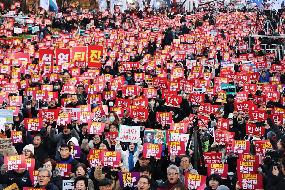 Protesters hold placards calling for the impeachment of President Yoon Suk Yeol in front of the National Assembly in Seoul, South Korea, Dec 7, 2024. 