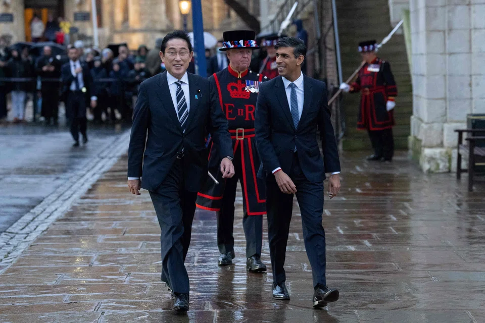 Britain's Prime Minister Rishi Sunak (right) and Japan's Prime Minister Fumio Kishida (left) walks towards the exit at the end of their bilateral meeting at the Tower of London, London, on Jan 11, 2023. Japan is hosting this year’s G7 and Kishida is visiting all bloc members except Germany on a trip capped by talks in Washington on Friday with US President Joe Biden.