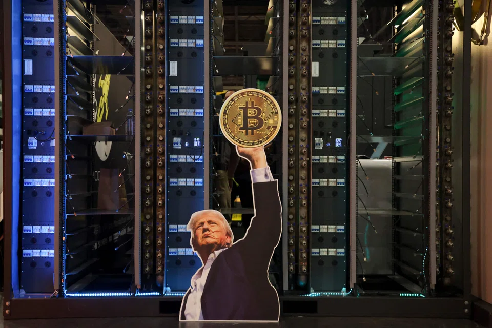 A cutout of US President Donald Trump holding a Bitcoin is displayed on a group of servers during The Bitcoin Conference at in Las Vegas in May.