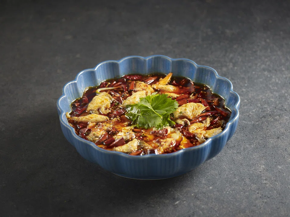 Silky sea bass floating in a fiery chilli oil broth.