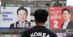Banners of Liberal front runner Lee Jae-myung (left) and conservative candidate Kim Moon-soo.